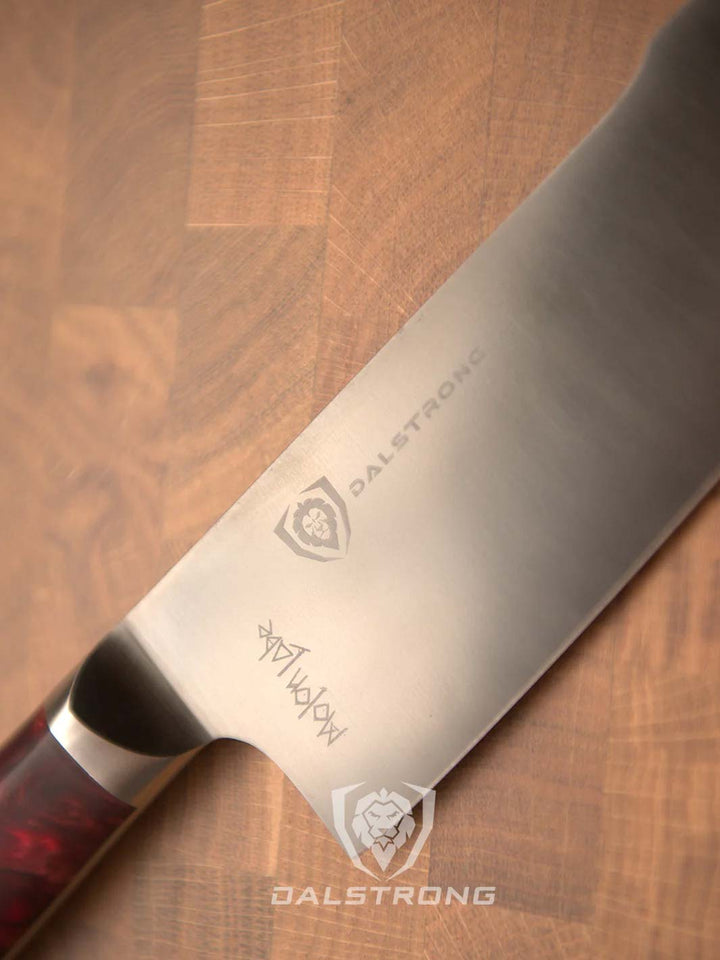 Dalstrong spartan ghost series 8 inch chef knife on a wooden cutting board.