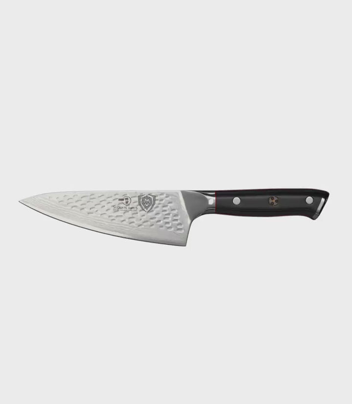 Dalstrong shogun series 6 inch chef knife with black handle in all angles.