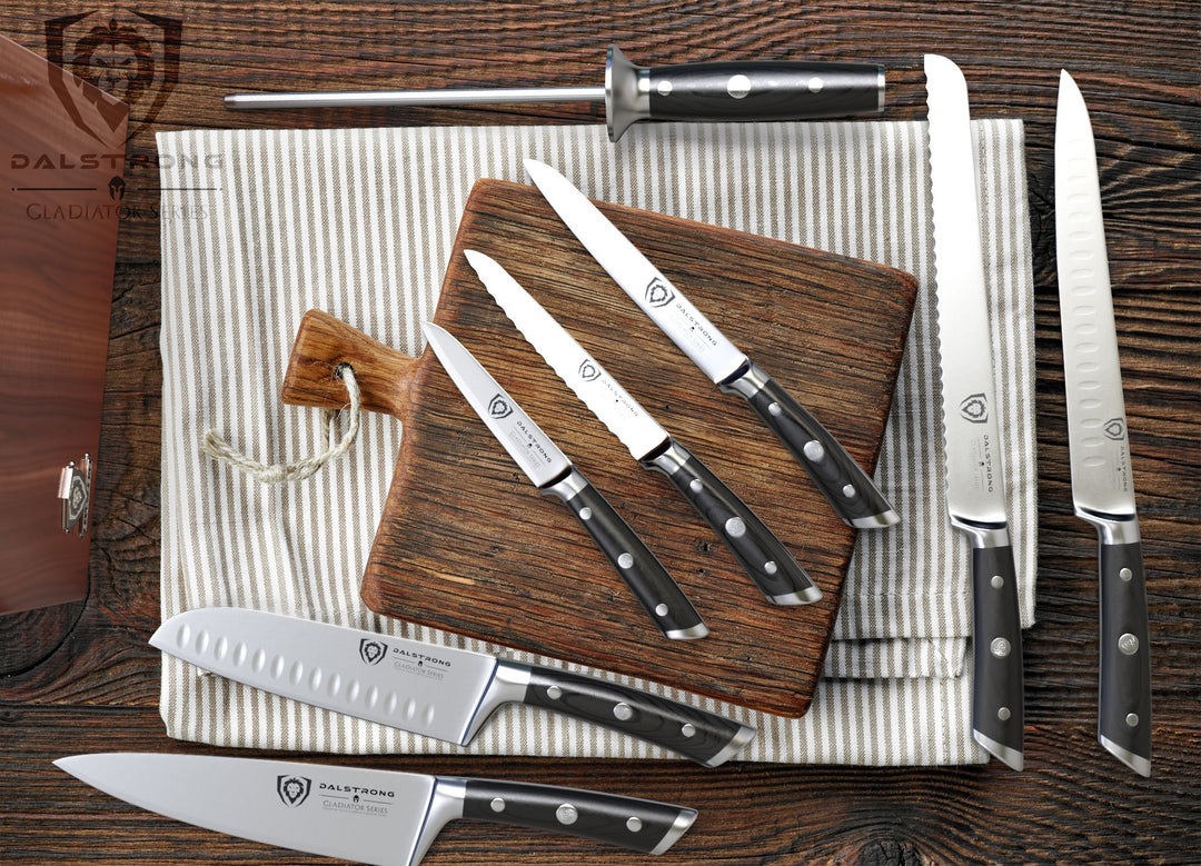 Dalstrong gladiator series 8 piece knife set with block on top of a wooden table.
