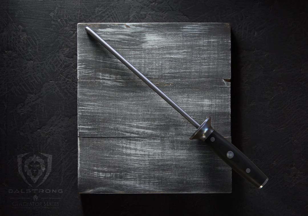 Dalstrong gladiator series 10 inch honing rod with black handle in top of a wooden board.