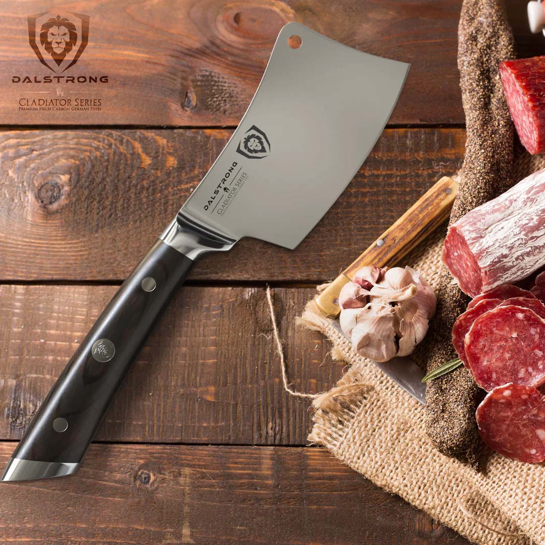 Dalstrong gladiator series 4.5 inch mini cleaver knife with black handle and slices of salami beside it.