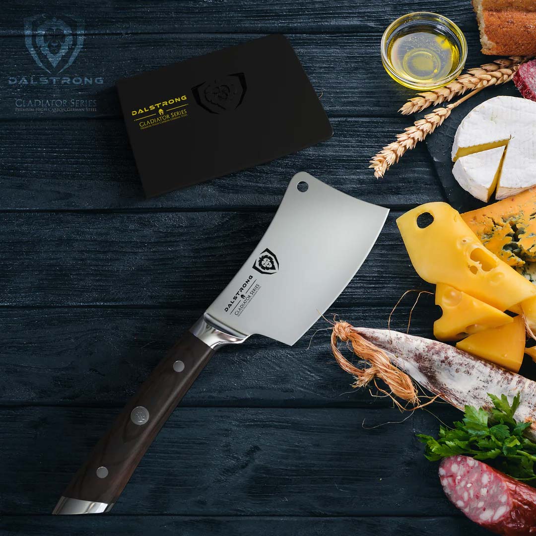 Dalstrong gladiator series 4.5 inch mini cleaver knife with black handle and different slices of cheese beside it.
