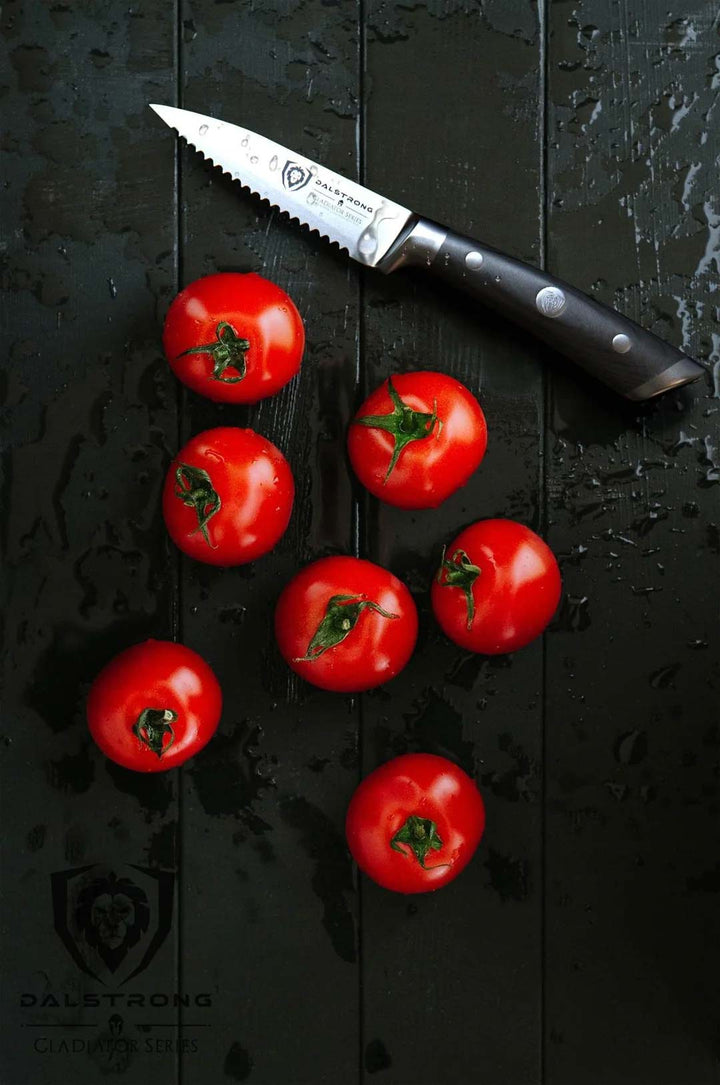 Dalstrong gladiator series 3.75 inch serrated paring knife with black handle and seven red tomatoes.