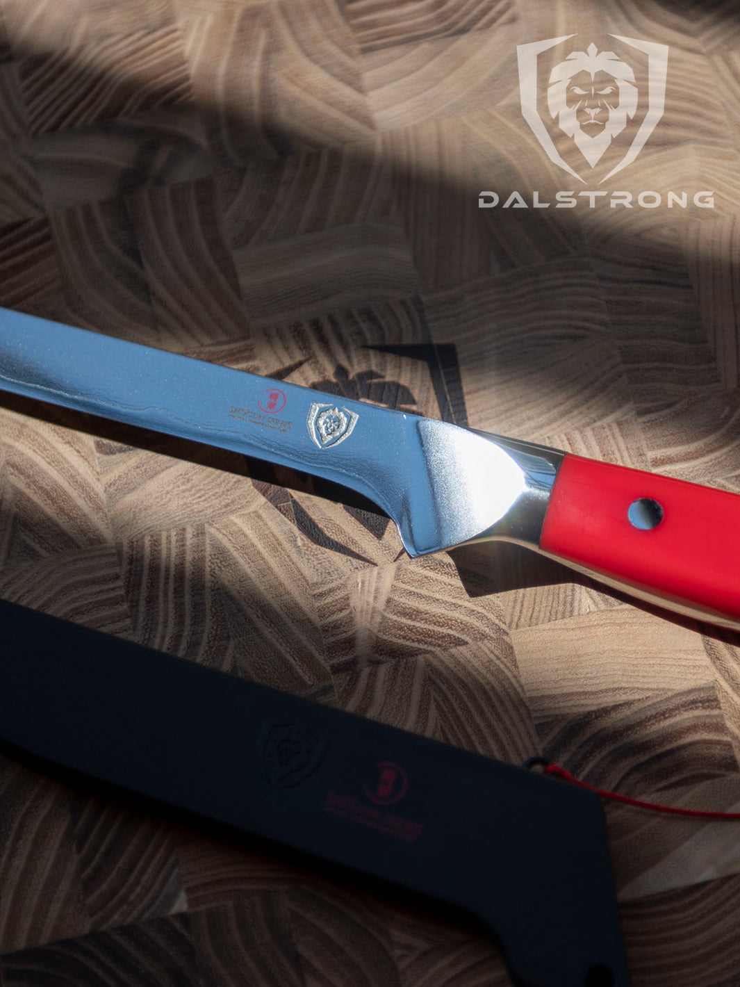 Dalstrong shogun series 6 inch boning knife with red handle and black sheath in top of a dalstrong wooden board.
