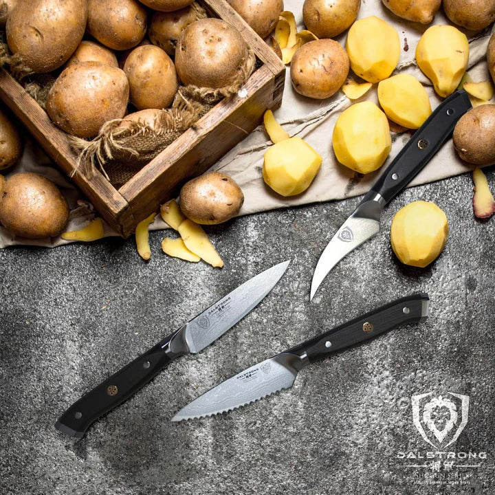 Dalstrong shogun series 3 piece paring knife set with black handles and peeled potatoes at the top.