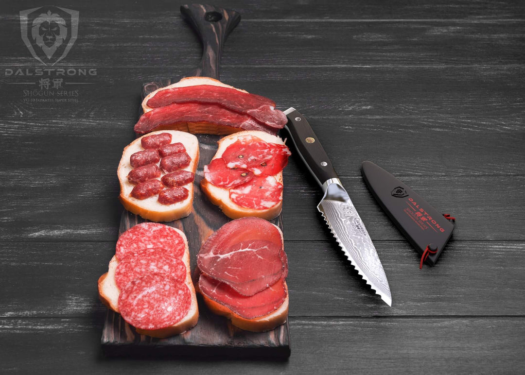 Dalstrong shogun series 3.5 inch serrated paring knife with black handle and five kinds of sandwich on a wooden board.