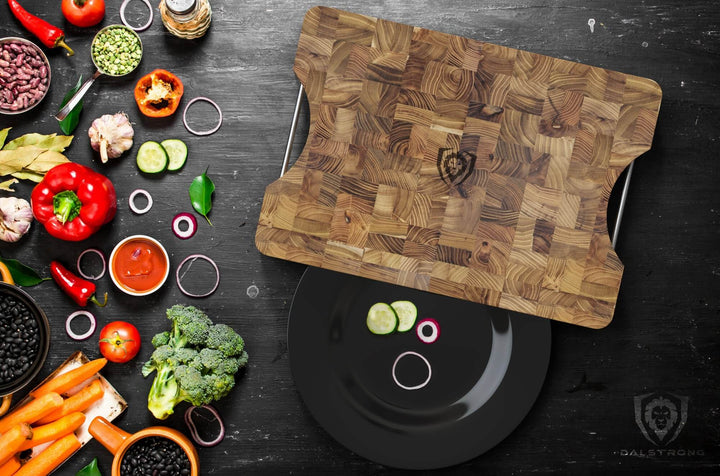 Dalstrong lionswood teak cutting board medium size with vegetables on the side.