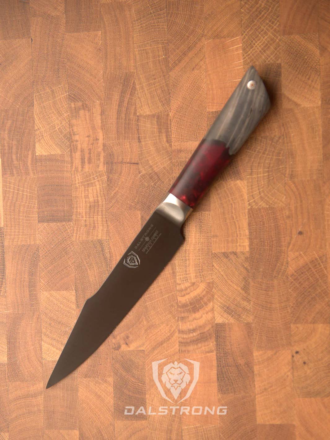Dalstrong spartan ghost series 6 inch utility knife on a cutting board.
