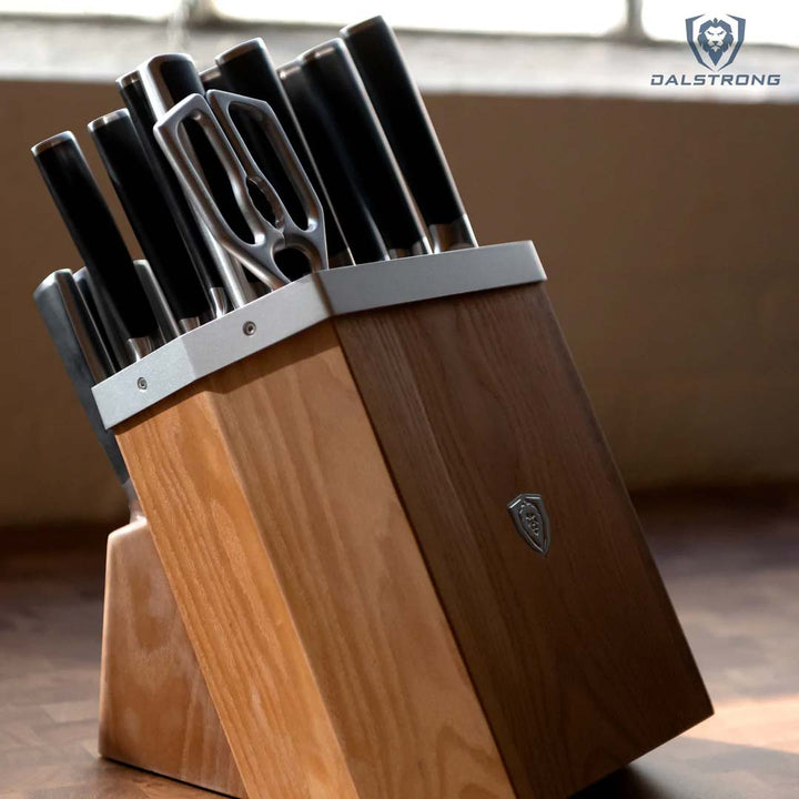 Dalstrong vanquish series 24 piece knife with block set on top of a wooden table.